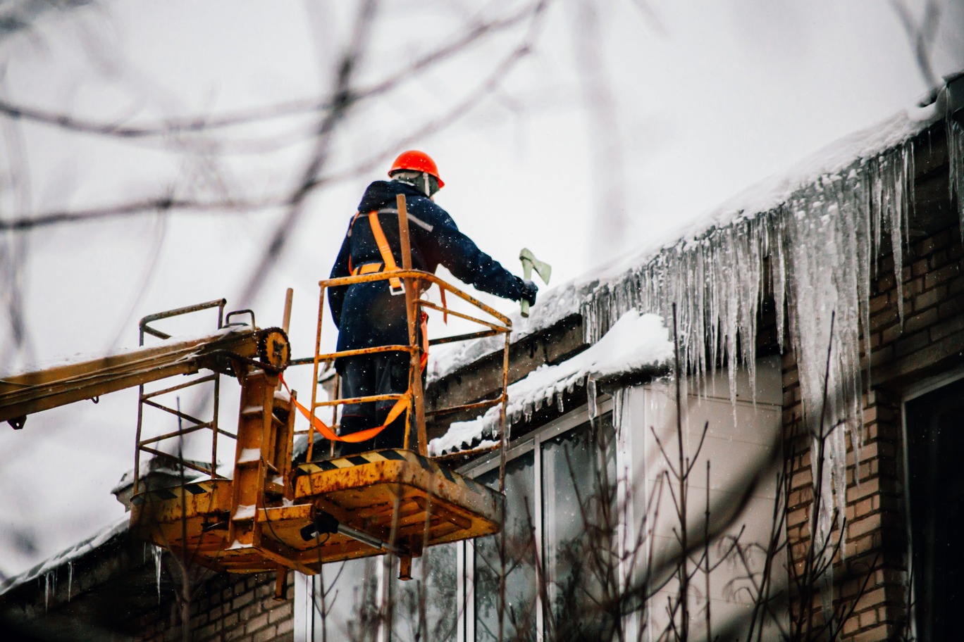 a utility worker knocks down huge icicles 2024 12 04 01 39 43 utc min